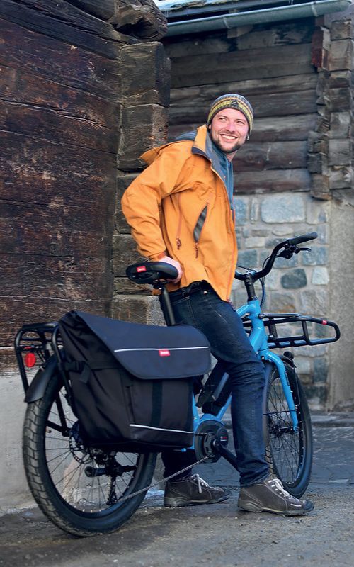 man with longtail cargo bike and panniers