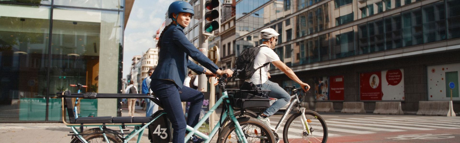 A woman using a cargo bike to ride to work